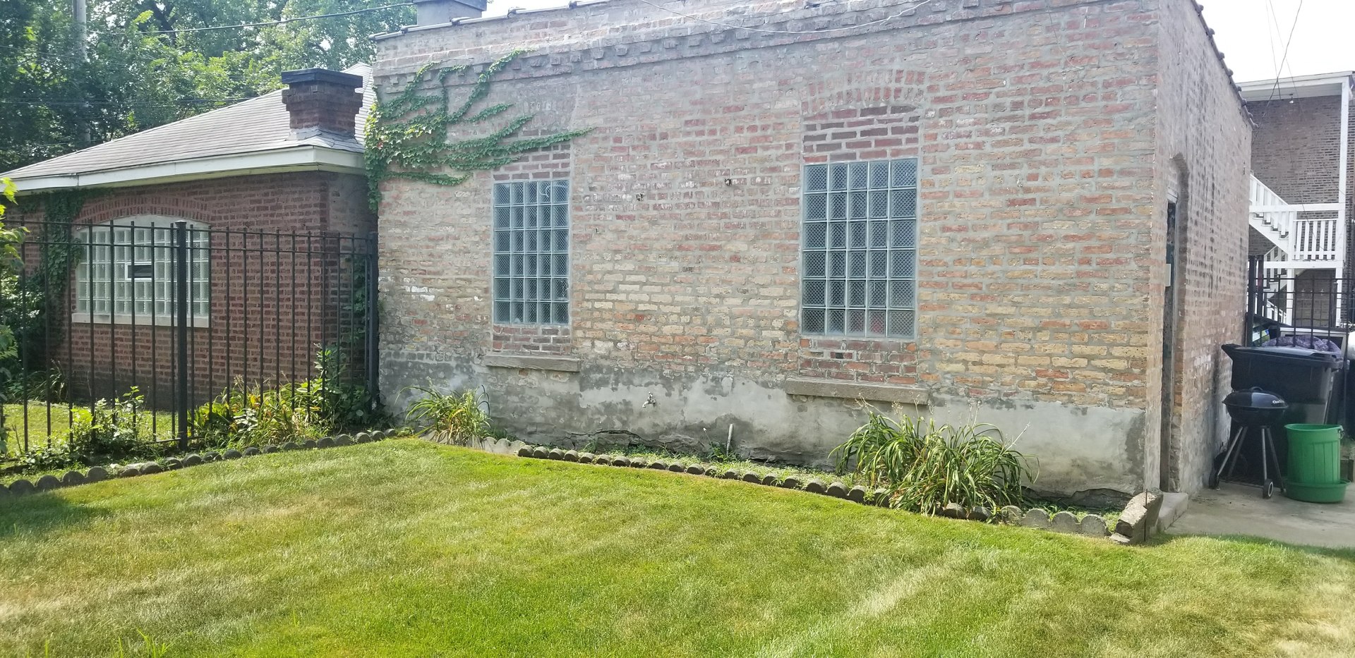 7418 South Rhodes Avenue Chicago, IL 60619 - Photo 37 of 41 a front view of a house with garden