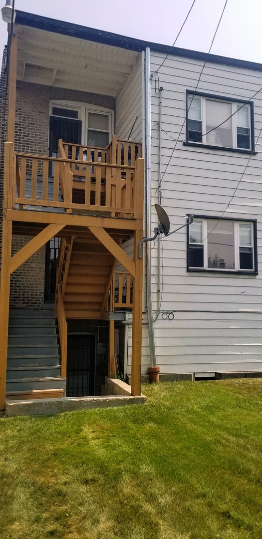 7418 South Rhodes Avenue Chicago, IL 60619 - Photo 39 of 41 a front view of a house with a garden