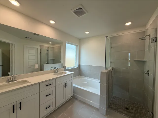 a bathroom with a double vanity sink mirror double and shower