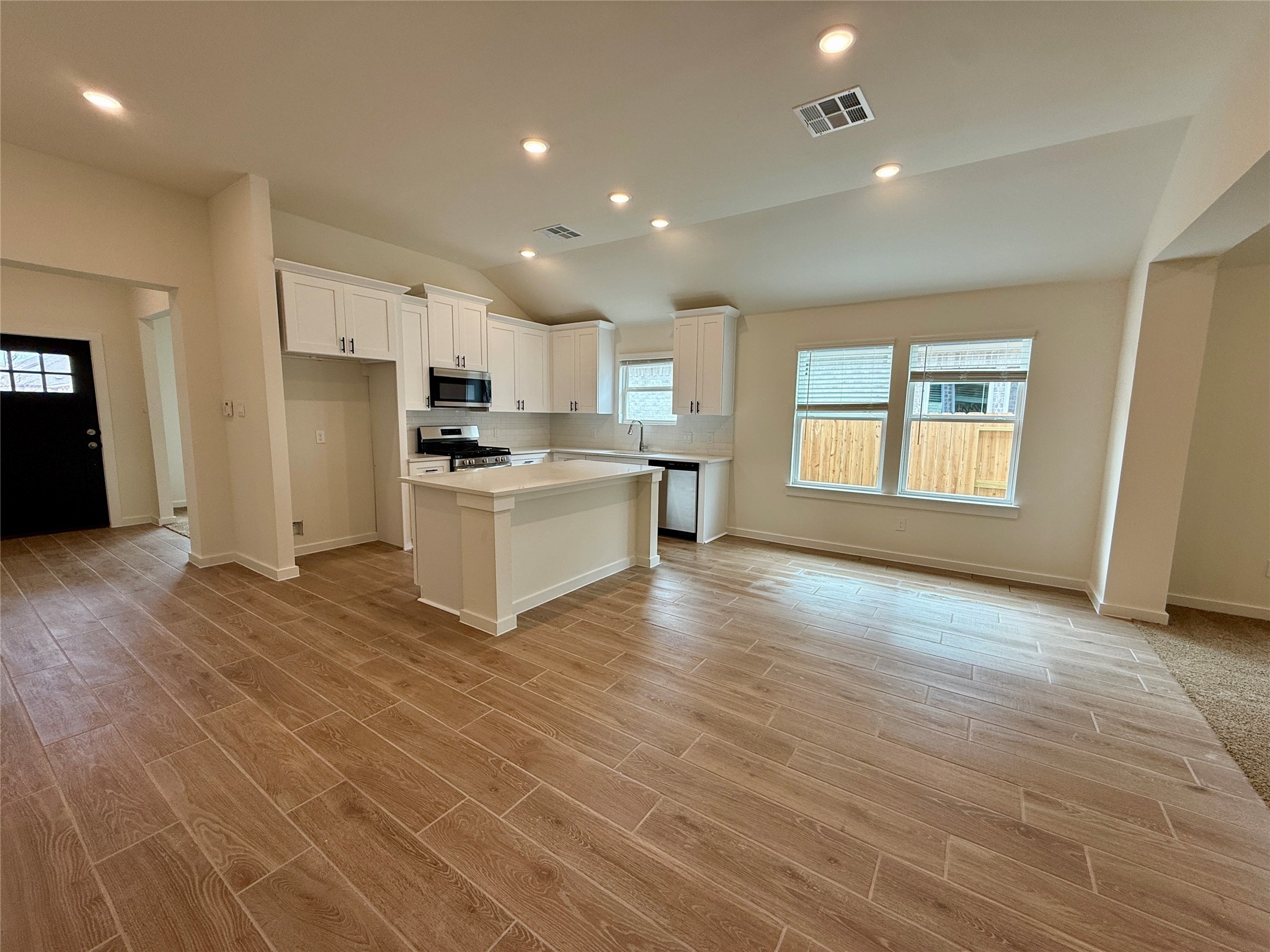 3130 Emerald Hills Drive Angleton, TX 77515 - Photo 4 of 17 a view of a kitchen with a sink and a stove top oven