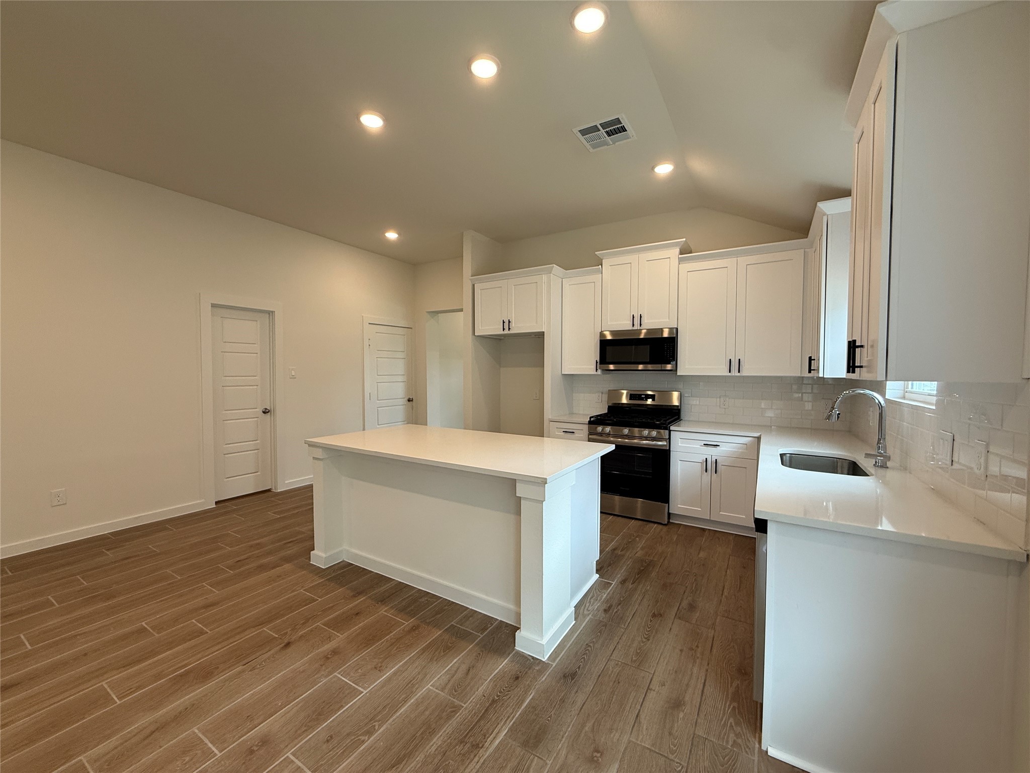 3130 Emerald Hills Drive Angleton, TX 77515 - Photo 5 of 17 a kitchen with granite countertop a stove top oven and cabinets