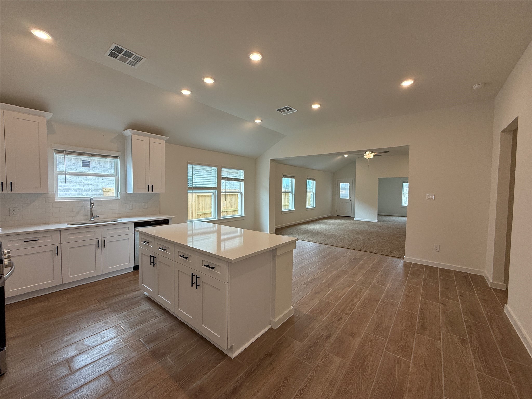 3130 Emerald Hills Drive Angleton, TX 77515 - Photo 6 of 17 a large kitchen with kitchen island a sink dishwasher a stove and wooden floors