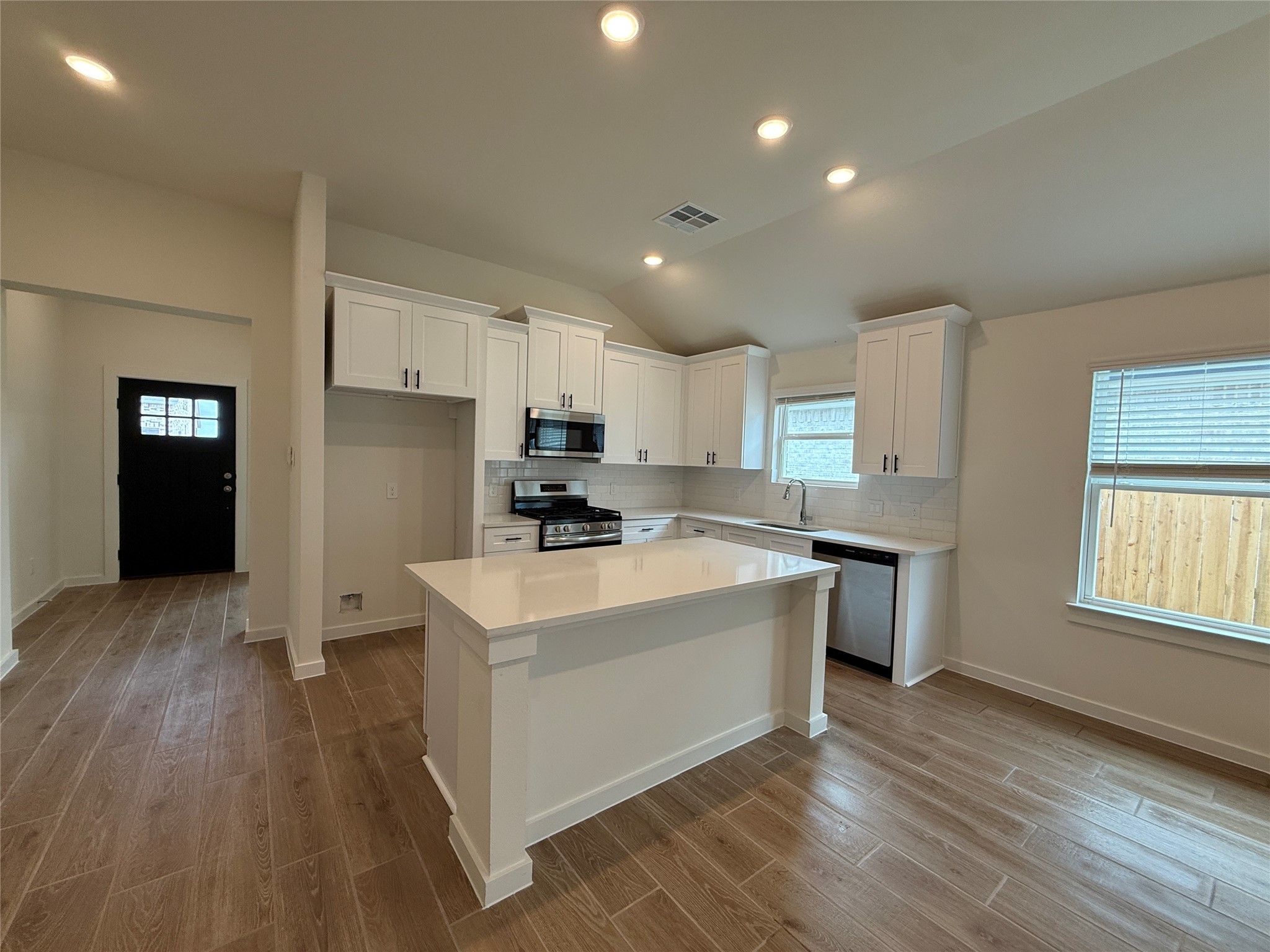 3130 Emerald Hills Drive Angleton, TX 77515 - Photo 8 of 17 a large kitchen with stainless steel appliances a large counter top and a stove top oven