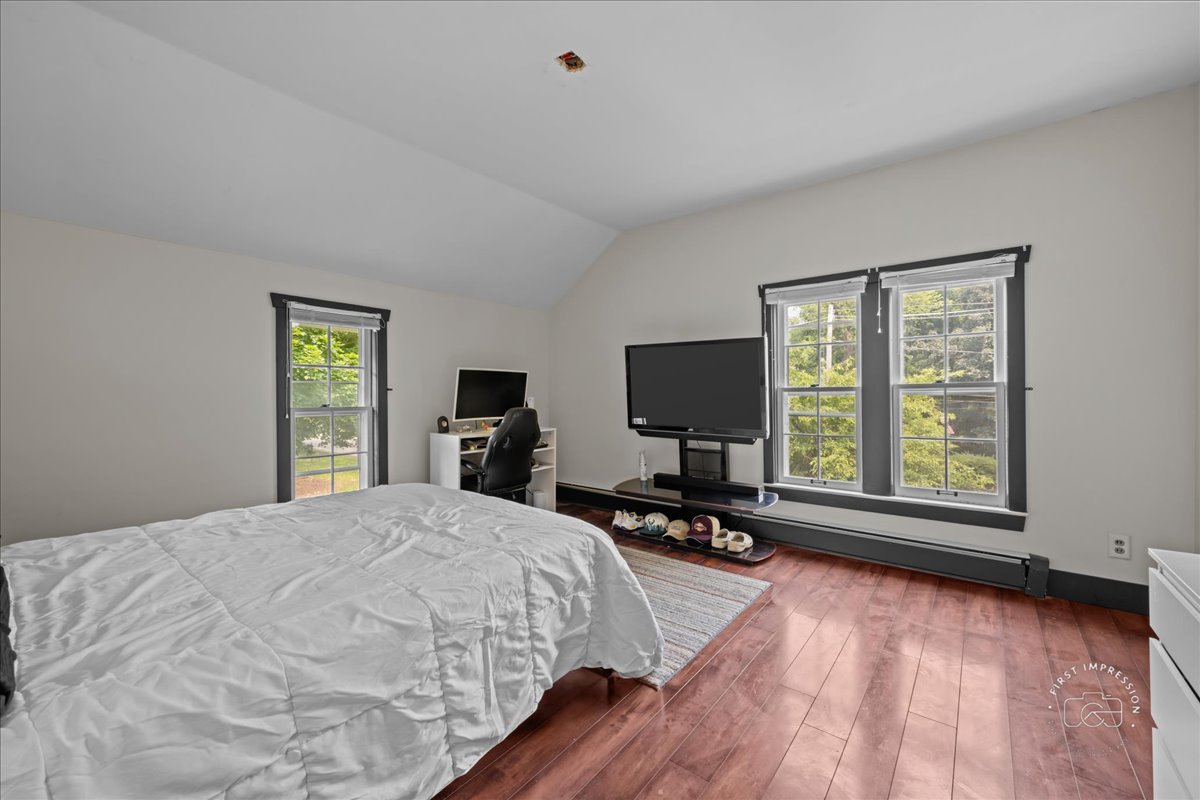 32W167 Army Trail Road Wayne, IL 60184 - Photo 13 of 19 a bedroom with a bed a large window and wooden floor