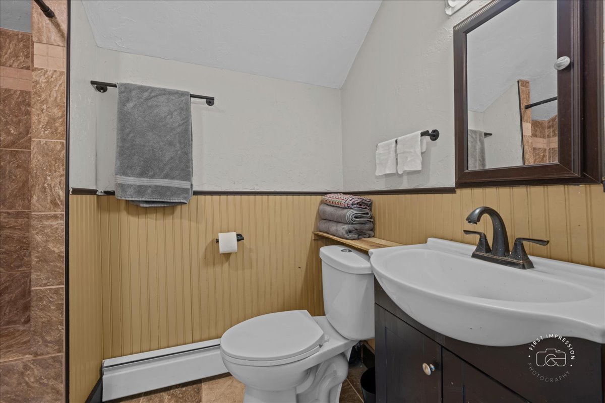 32W167 Army Trail Road Wayne, IL 60184 - Photo 16 of 19 a bathroom with a sink toilet and mirror