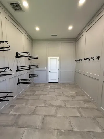 a view of a fountain in front of a house with a big yard