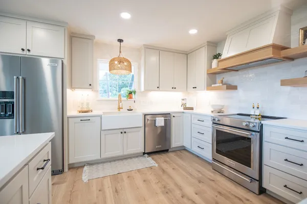 a kitchen with a sink stove and refrigerator