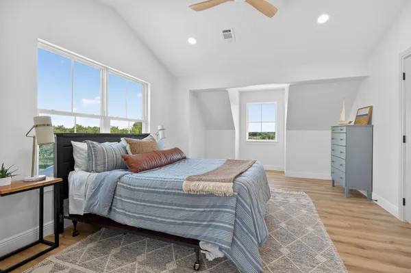a bedroom with a bed and a dresser