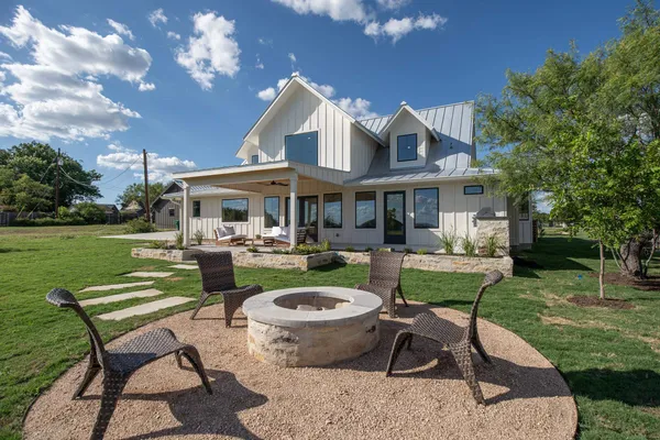 a view of a house with backyard porch and sitting area