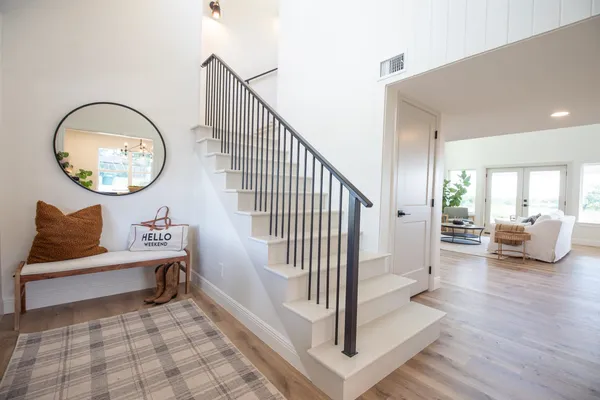 a view of a hallway with entryway wooden floor and front door