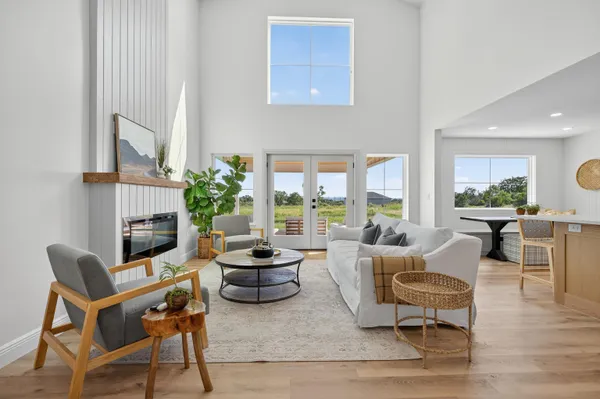 a living room with furniture fireplace and a large window