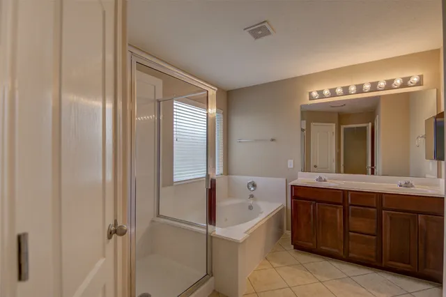 a bathroom with a tub sink and mirror