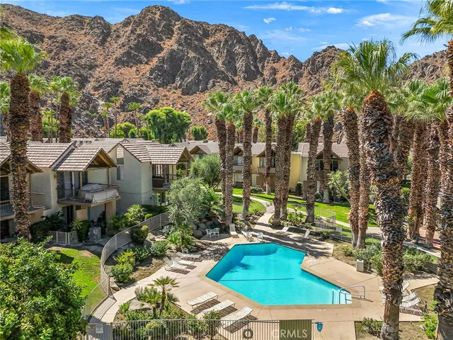 a view of a house with a yard and sitting area