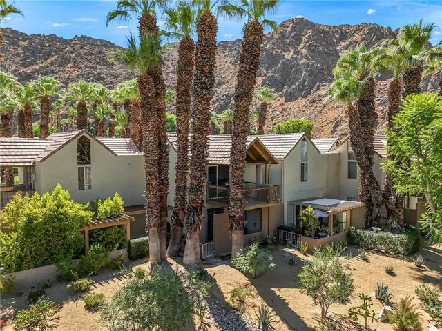 a view of a house with a yard and a garden