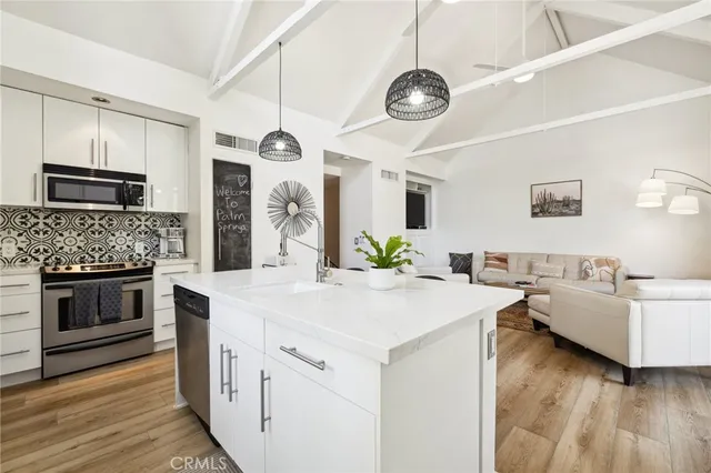 a view of living room kitchen with a stove and a fireplace