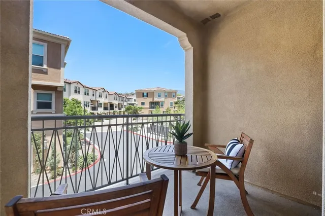 a view of a balcony with chair and wooden floor