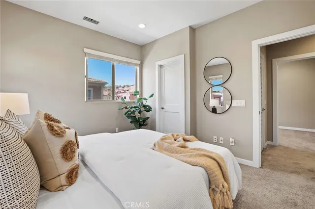 a bedroom with a bed flowerpot and wooden floor