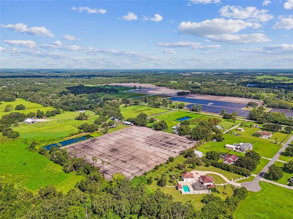 1715 West Sam Allen Road Plant City, FL 33565 - Photo 21 of 54 a view of a lake with a building in the background