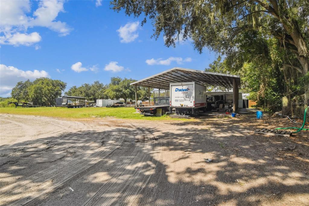 1715 West Sam Allen Road Plant City, FL 33565 - Photo 49 of 54 a view of a house with a swimming pool and a yard