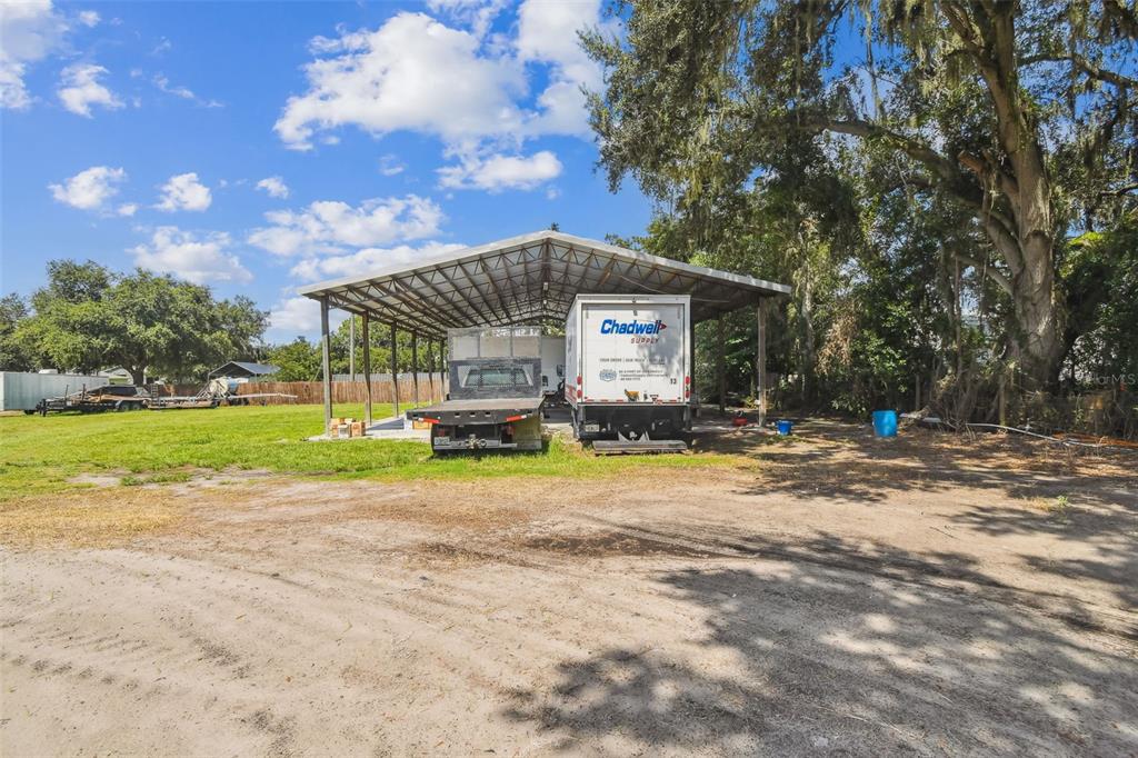 1715 West Sam Allen Road Plant City, FL 33565 - Photo 50 of 54 a view of a house with backyard and a tree