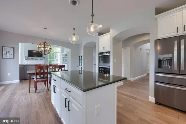 a living room with furniture a rug and a wall painting