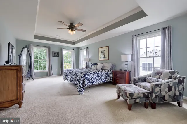 a bathroom with a bathtub a mirror and a shower