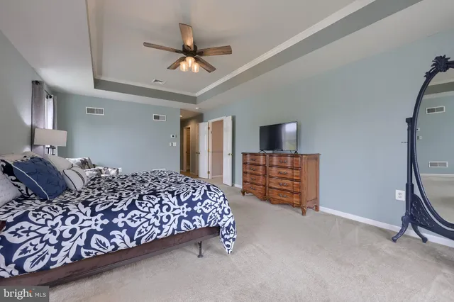 a large bathroom with a tub sink and mirror