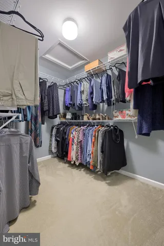 a spacious bedroom with a bed and a chandelier