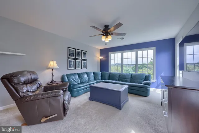 a spacious bedroom with a bed and a large window