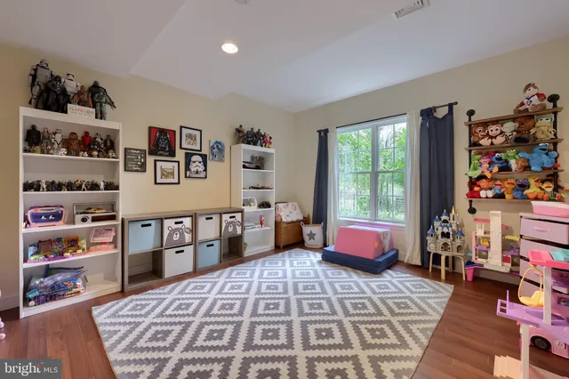 an aerial view of a house with a garden and lake view