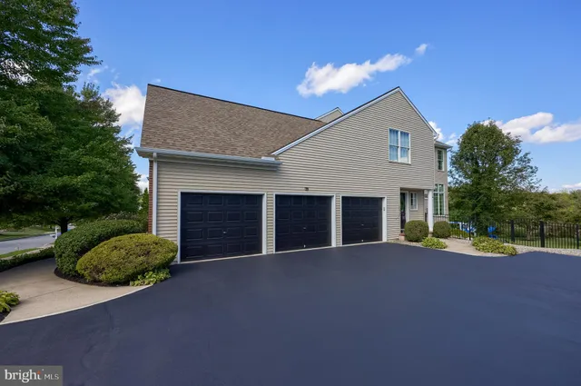 an aerial view of residential houses with yard