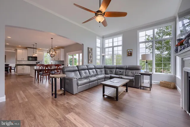 a kitchen with stainless steel appliances kitchen island granite countertop a stove a sink and a refrigerator