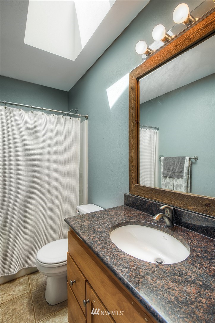 201 Morgan Road Everett, WA 98203 - Photo 14 of 29 a bathroom with a granite countertop sink and a mirror