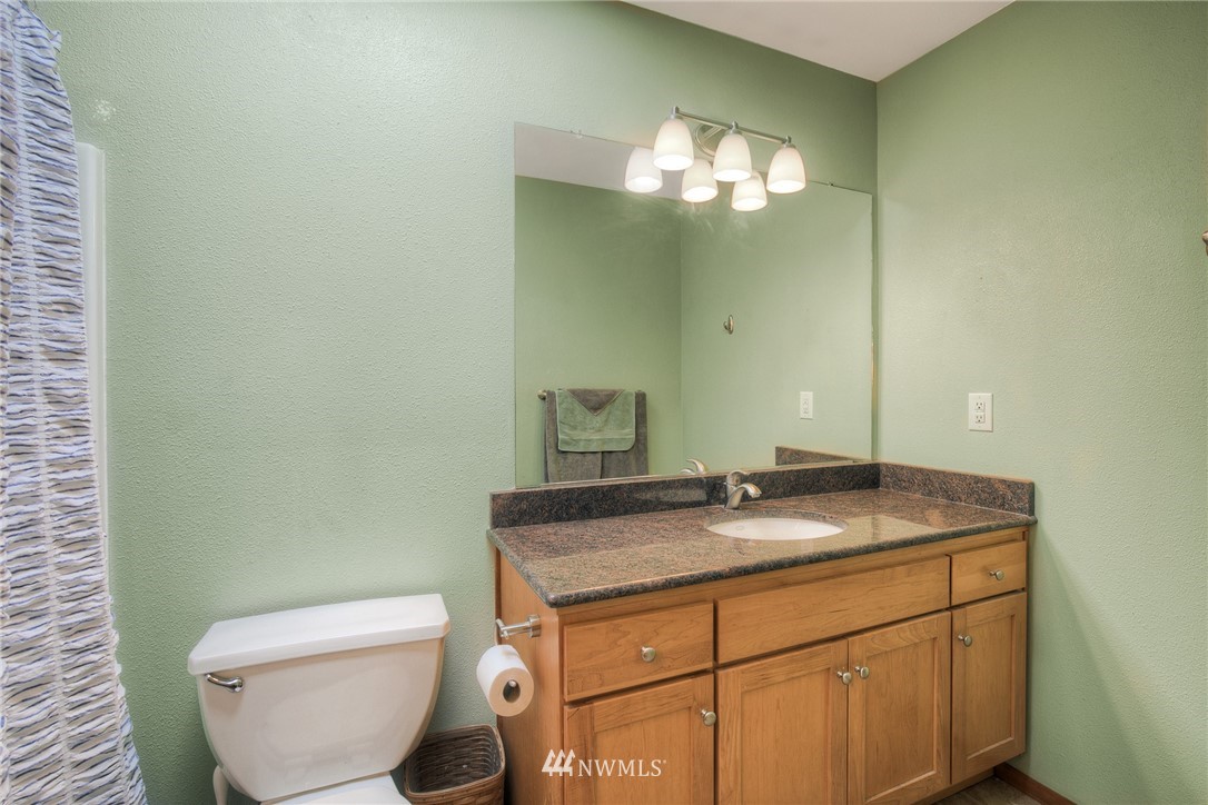 201 Morgan Road Everett, WA 98203 - Photo 19 of 29 a bathroom with a granite countertop toilet sink and mirror