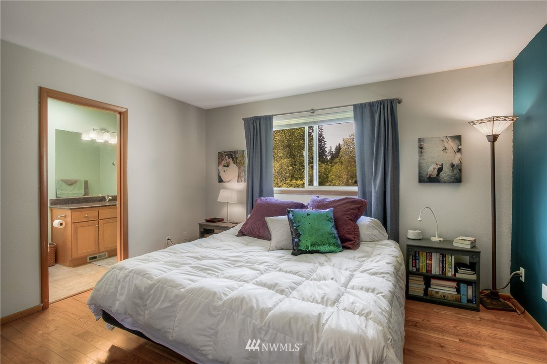 201 Morgan Road Everett, WA 98203 - Photo 20 of 29 a bedroom with a large bed and a wooden floor