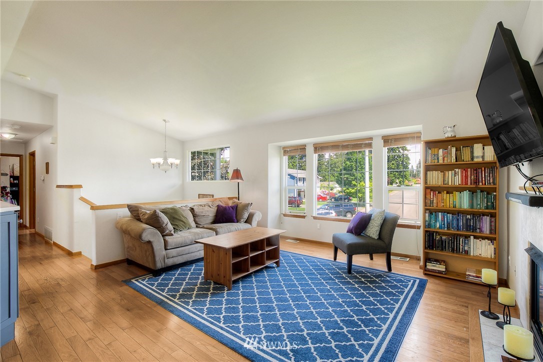 201 Morgan Road Everett, WA 98203 - Photo 4 of 29 a living room with furniture a rug and a flat screen tv