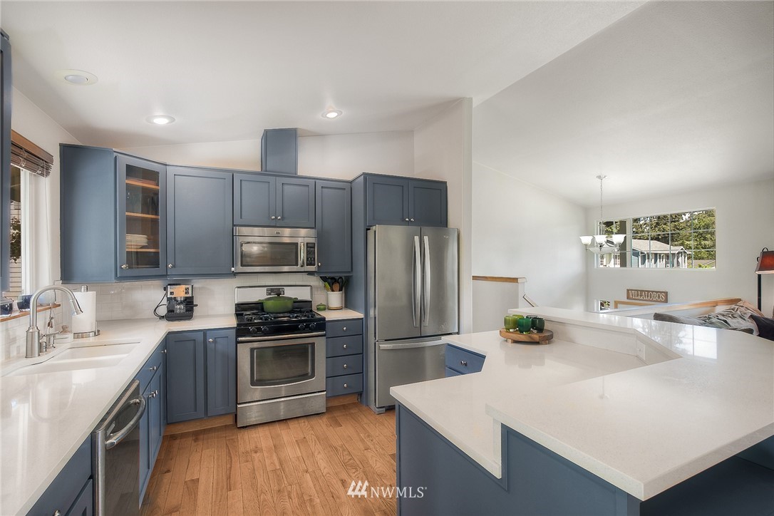 201 Morgan Road Everett, WA 98203 - Photo 8 of 29 a kitchen with kitchen island a sink stove and refrigerator