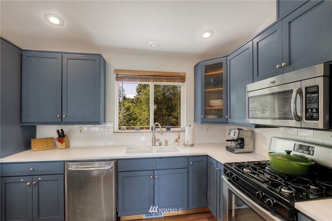 201 Morgan Road Everett, WA 98203 - Photo 9 of 29 a kitchen with stainless steel appliances a stove a sink and a microwave