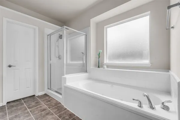 a bathroom with a bathtub and a shower