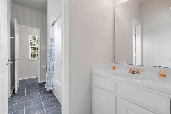 a bathroom with a sink and mirror