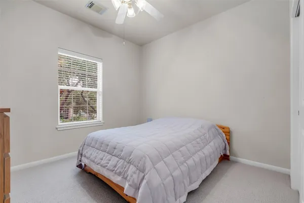 a bed sitting in a bedroom next to a window