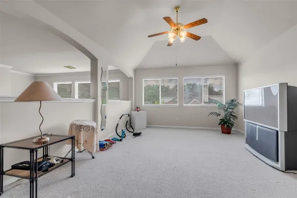 a view of a livingroom with furniture and a ceiling fan