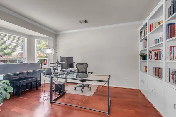 a work room with furniture and a book shelf