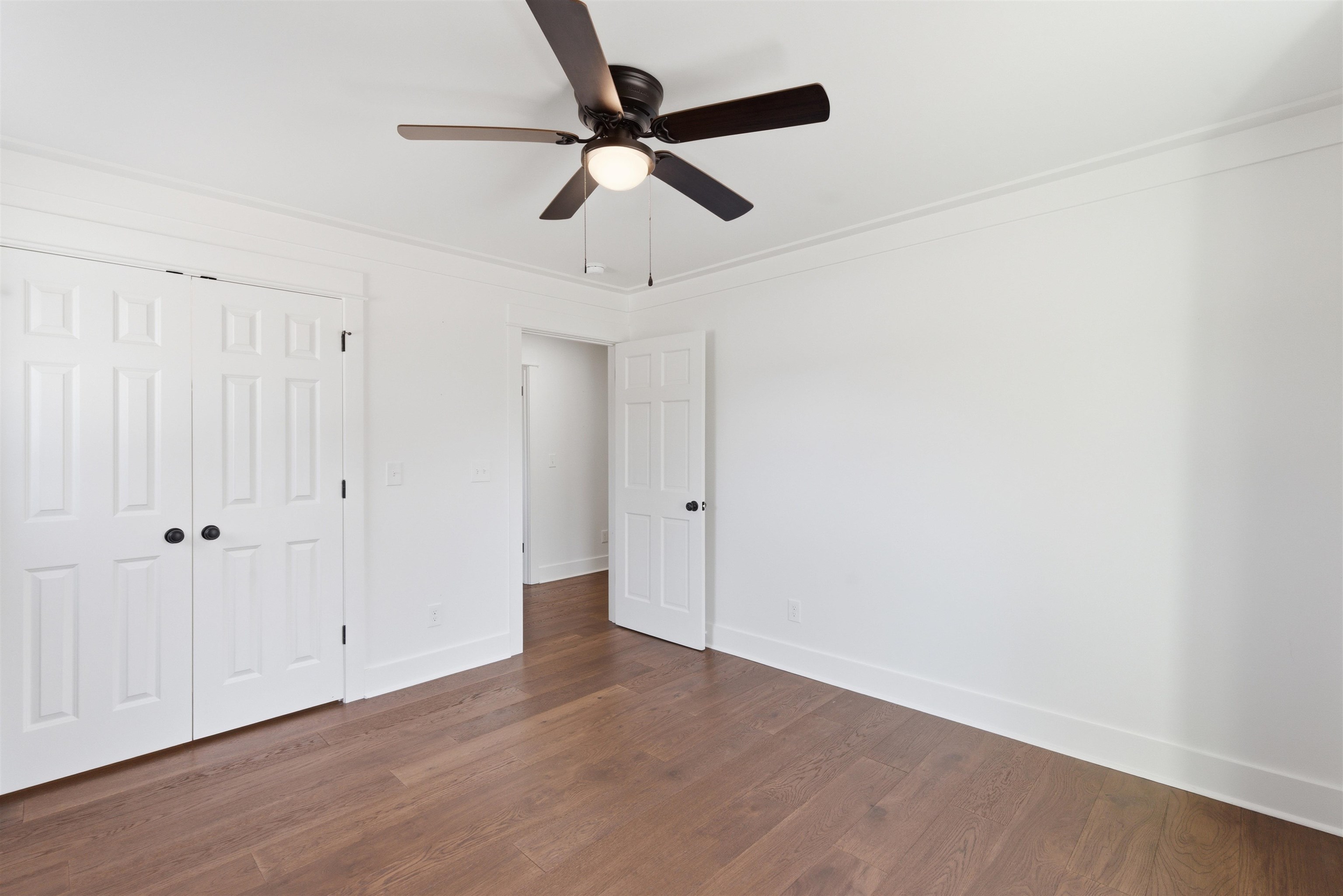222 Barrett Street Bolivar, TN 38008 - Photo 15 of 30 Unfurnished bedroom with a closet, dark wood-style floors, and ceiling fan