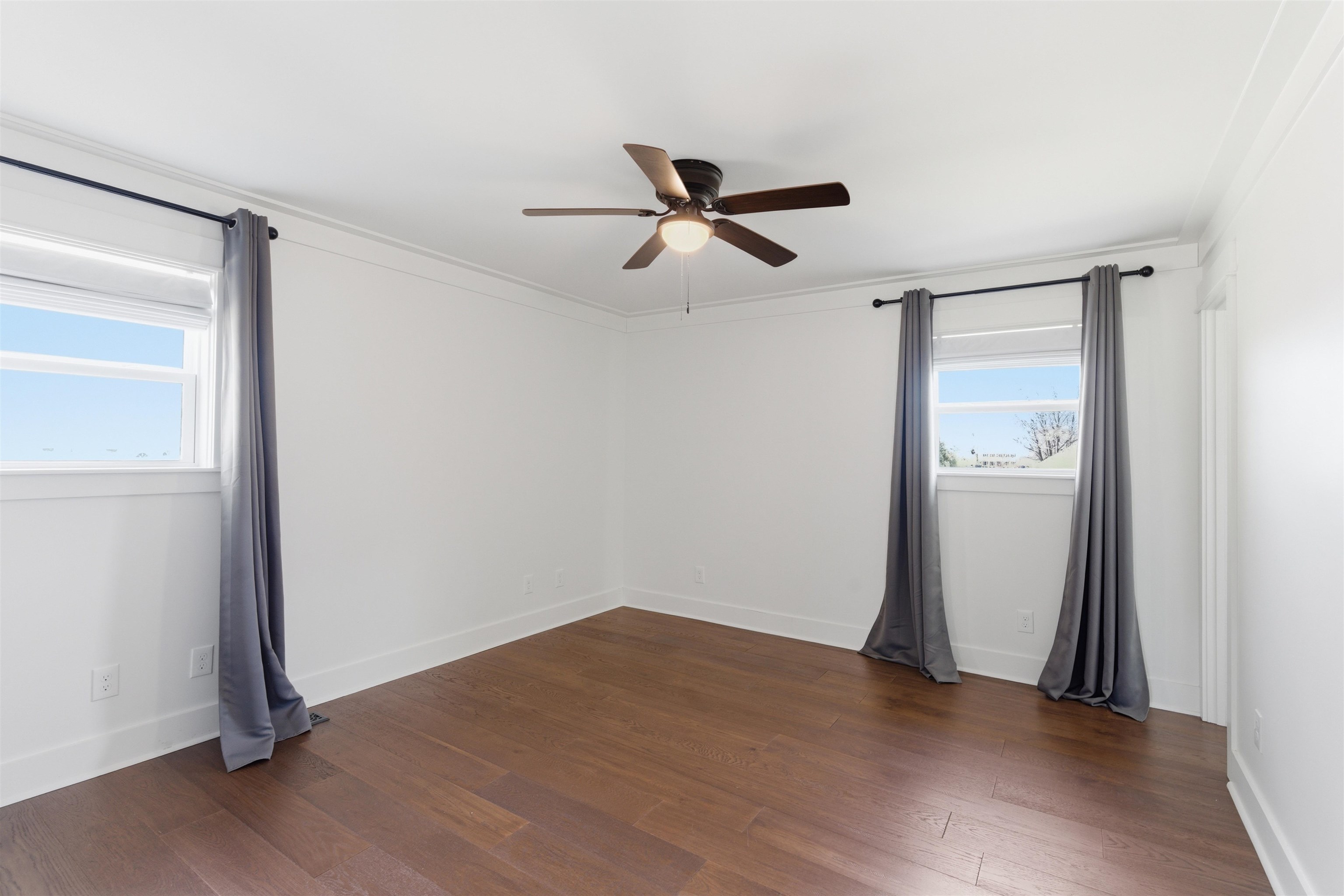 222 Barrett Street Bolivar, TN 38008 - Photo 16 of 30 Spare room featuring dark wood finished floors, a ceiling fan, and crown molding