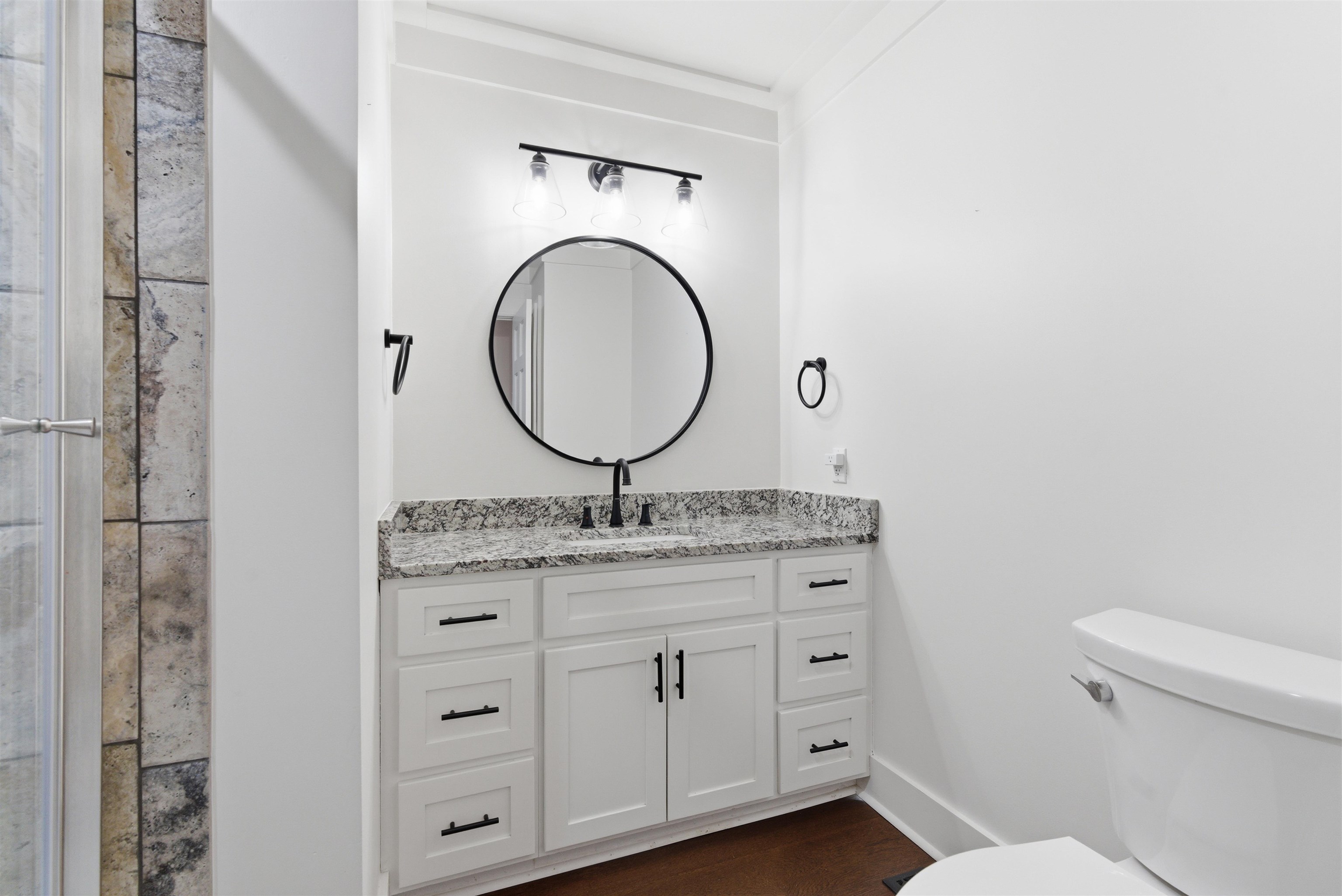 222 Barrett Street Bolivar, TN 38008 - Photo 18 of 30 Bathroom with vanity and dark wood-type flooring