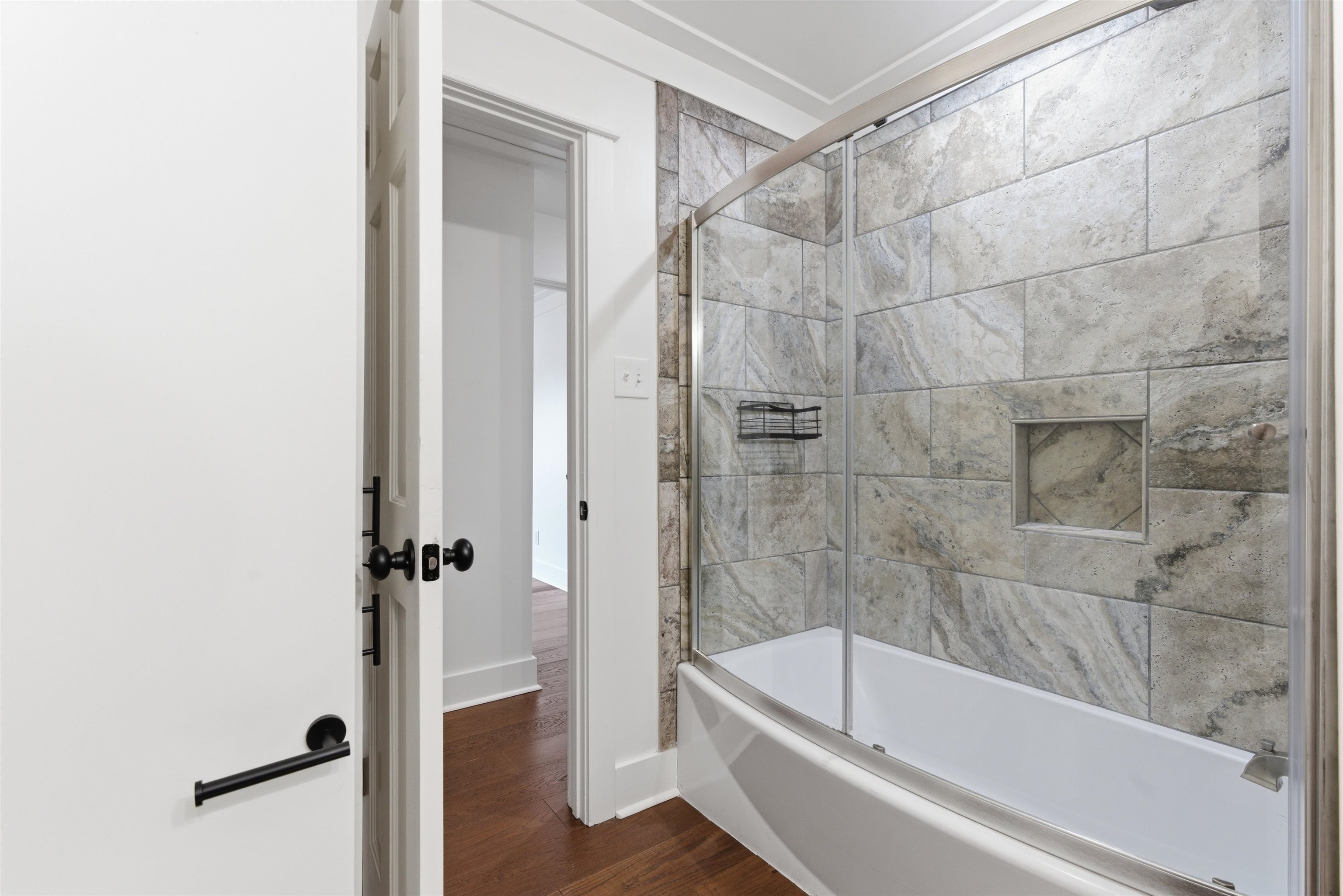 222 Barrett Street Bolivar, TN 38008 - Photo 19 of 30 Bathroom featuring bath / shower combo with glass door and dark wood-style flooring