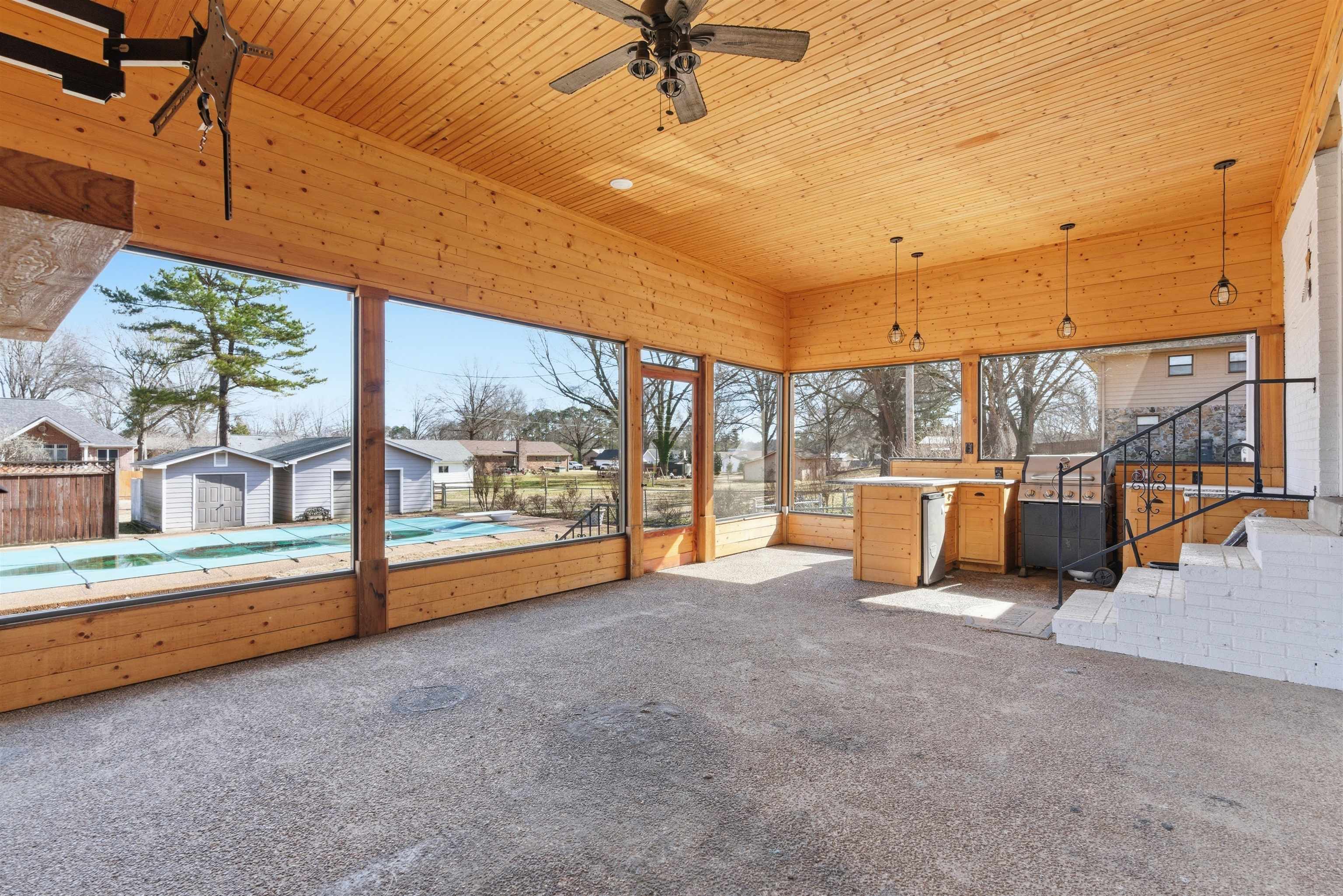 222 Barrett Street Bolivar, TN 38008 - Photo 25 of 30 Unfurnished sunroom featuring carpet floors, wood ceiling, a residential view, and a jacuzzi