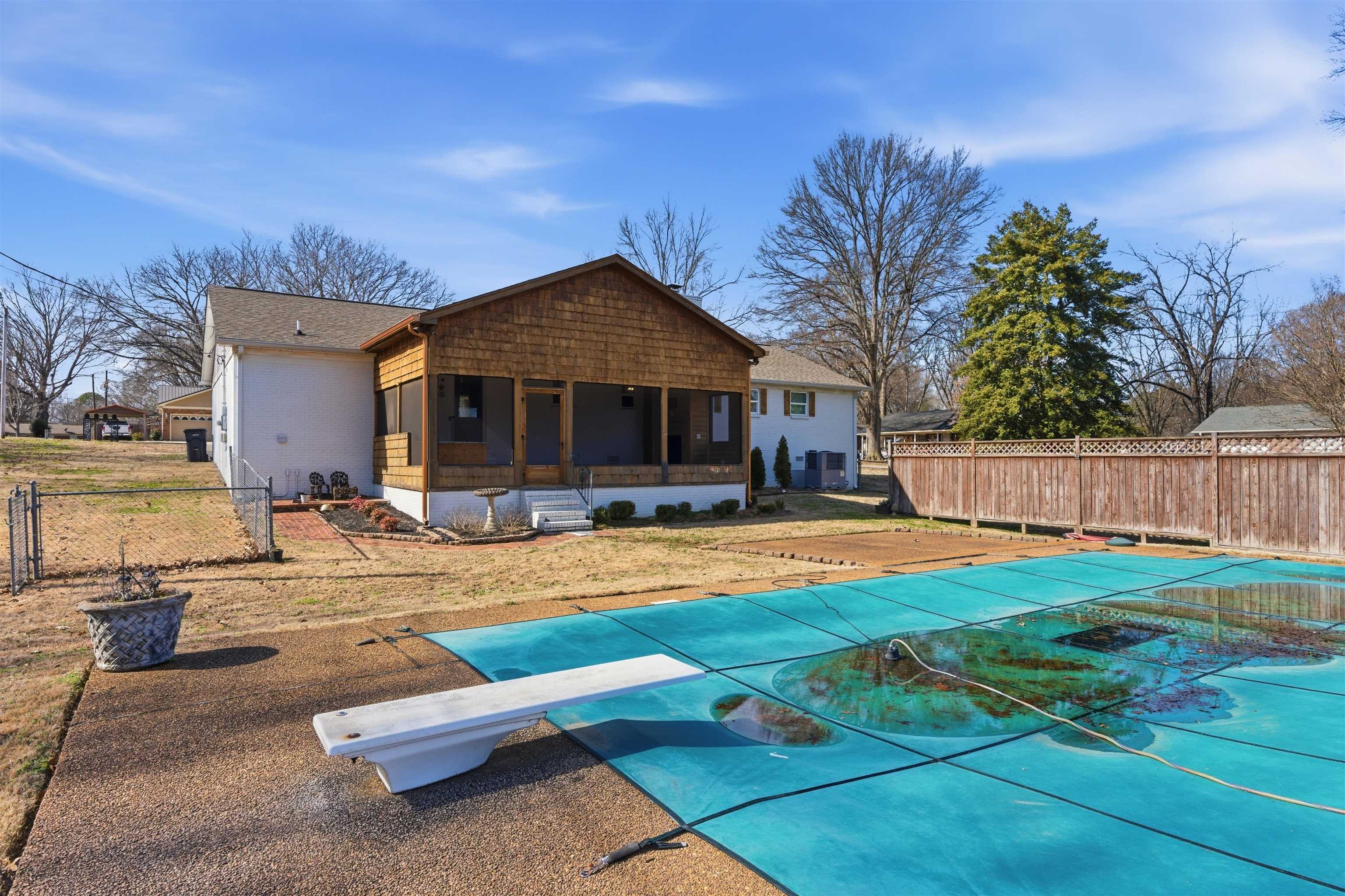222 Barrett Street Bolivar, TN 38008 - Photo 26 of 30 Rear view of property with a fenced backyard and a sunroom