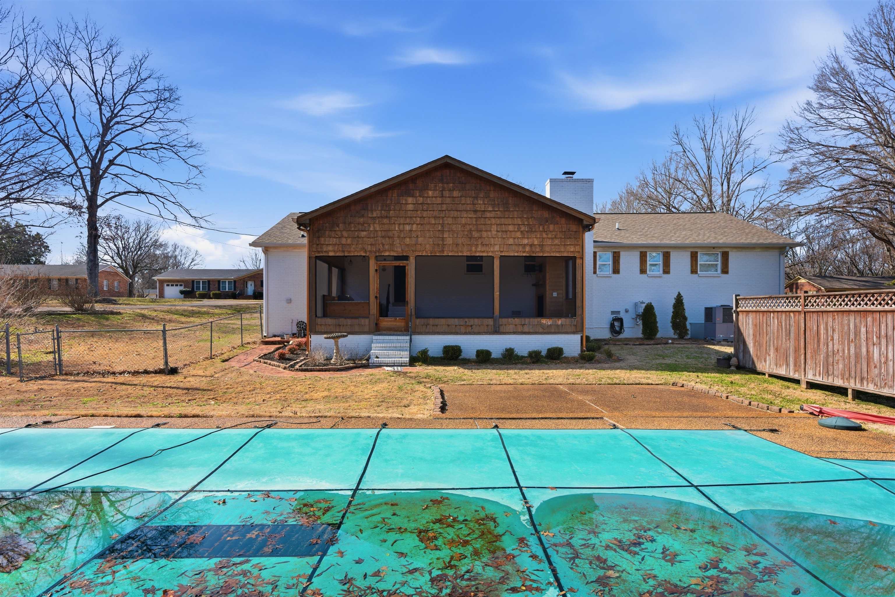 222 Barrett Street Bolivar, TN 38008 - Photo 27 of 30 Back of house featuring a sunroom and a chimney